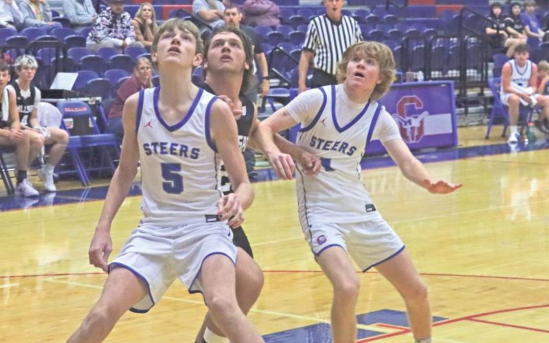(TC GORDON | THE GRAHAM LEADER) Graham’s Jaden Neal and Tyler Allen work together to box out a Millsap player as they all look for a rebound Tuesday, Nov. 19 in the Steers’ 51-40 win, their first of the season.