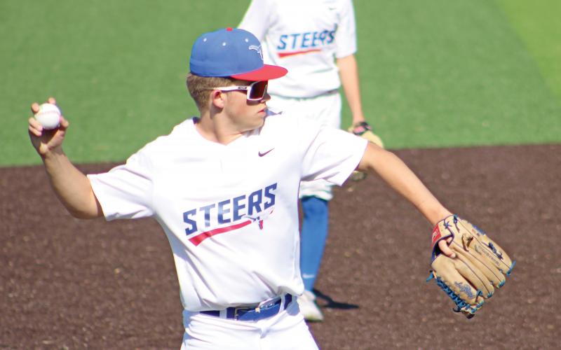 (ALEX HAVARDANSKY | THE GRAHAM LEADER) Dylan Cox picks up a ground ball at third base to make the out against the Mineral Wells Rams in the afternoon Tuesday, April 8. Cox was a bright spot in the infield for the Steers.