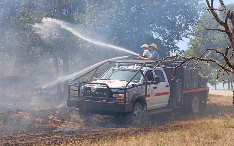 (FILE PHOTO | THE GRAHAM LEADER) Members of the Newcastle Volunteer Fire Department control a fire on FM 3109 which broke out Sunday, July 30 in Young County and threatened structures. The department was recently awarded a grant from Texas A&M Forest Service.