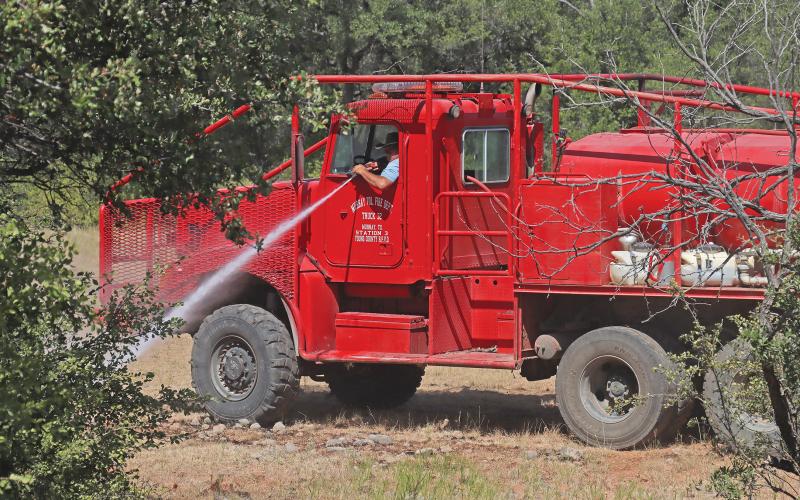 (FILE PHOTO | THE GRAHAM LEADER) Members of the Murray Volunteer Fire Department control a fire on FM 3109 which broke out Sunday, July 30 in Young County and threatened structures. The department was recently awarded grants from Texas A&M Forest Service.