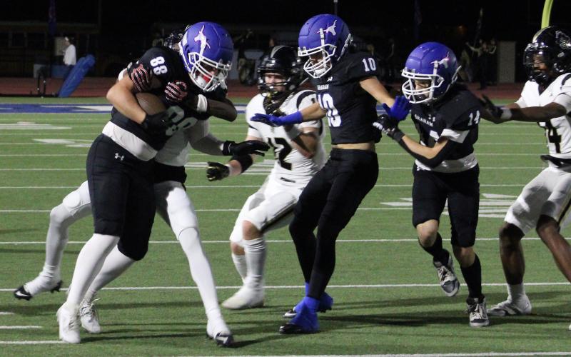 (ALEX HAVARDANSKY | THE GRAHAM LEADER) Jacob Alexander runs through Knights defenders Friday, Nov. 7 against Eagle Mountain. Alexander was effective in the receiving game marching the Steers down field and pushing through defenders.