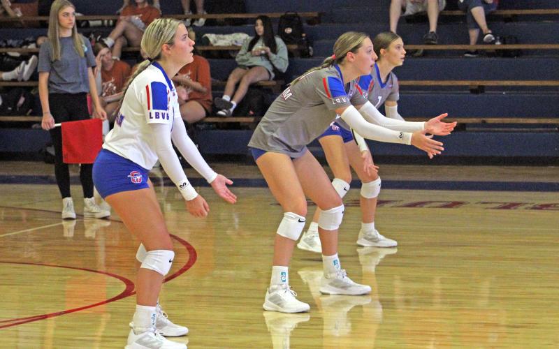 (ALEX HAVARDANSKY | THE GRAHAM LEADER) Members of the back row for the Lady Blues, from left to right being Kaden Atwood, Braylee Mayes and Katy McGehee, prepare for a service attempt at the 2024 Lu Allen Memorial Volleyball Tournament. The Lady Blues finished second last year in the tournament.