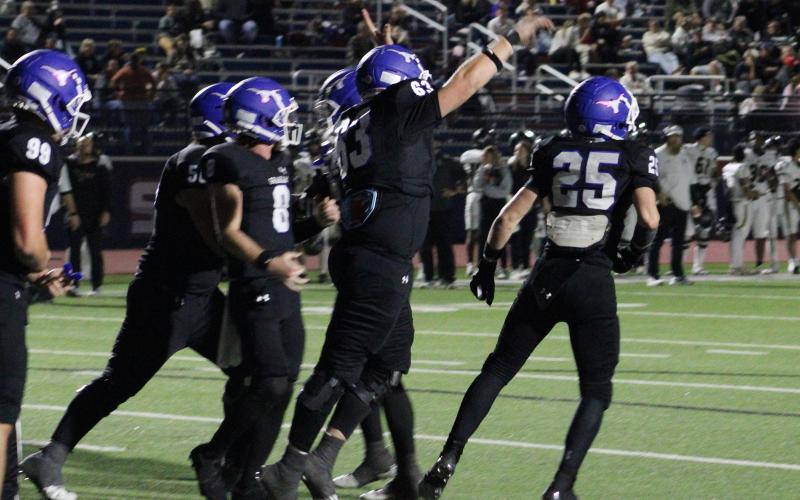 (ALEX HAVARDANSKY | THE GRAHAM LEADER) The Steers celebrate with Colt Taylor, 25, after he punched in the go ahead touchdown Friday, Nov. 7 against Eagle Mountain. The Steers went on to beat the Knights 20-18.