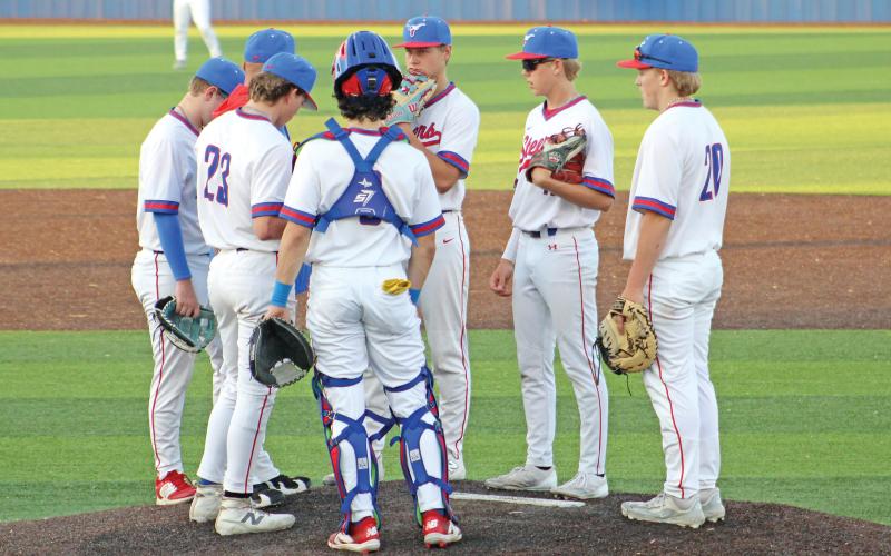(ALEX HAVARDANSKY | THE GRAHAM LEADER) The Steers up at the mound for a mound visit Tuesday, April 8. Graham’s pitching staff was very strong in the game.