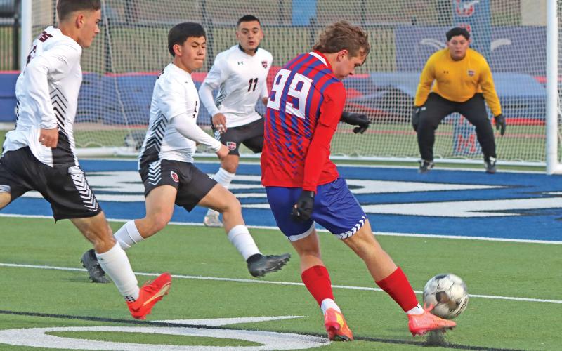 (THOMAS WALLNER | THE GRAHAM LEADER) Easton Hedge attempts a shot after running past the defense of the Mineral Wells Rams during the rematch against the team Tuesday, March 4. The game turned into a battle of the elements with cold and wind pushing back against both teams.