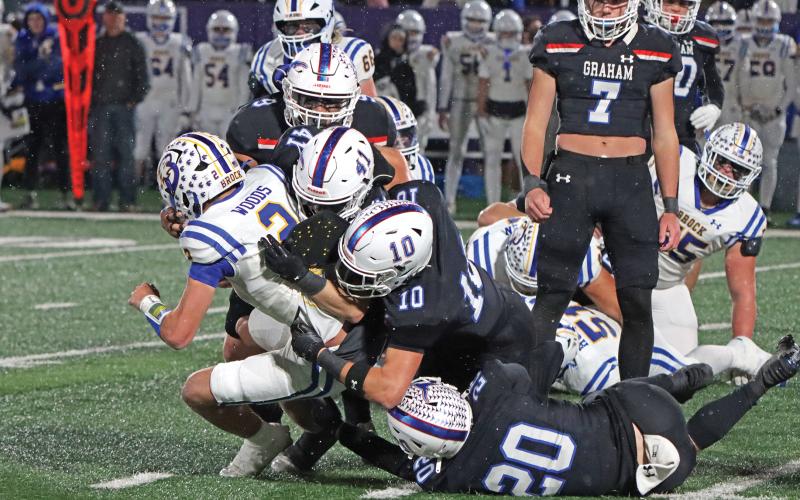 (ARCHIVE PHOTO | THE GRAHAM LEADER) Multiple Graham defenders dog pile the opposing Brock quarterback Friday, Dec. 6 during part of the Steers’ 12-10 triple overtime loss to the Eagles.