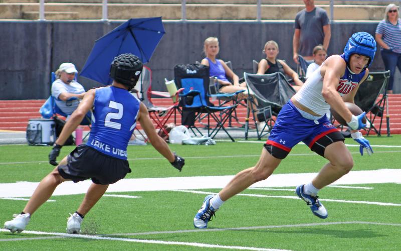 (ALEX HAVARDANSKY | THE GRAHAM LEADER) Brodie Martin jukes a Lake View defender and takes a pass to the endzone for a touchdown Saturday, May 31. The Martin Brothers were once again very effective and top targets of quarterback Jace Gill.