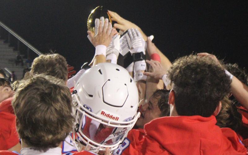 (ALEX HAVARDANSKY | THE GRAHAM LEADER) The Steers celebrate with their Bi-District championship trophy Friday, Nov. 14 after defeating the Godley Wildcats. The Steers beat the Wildcats in a 32-0 shutout victory.