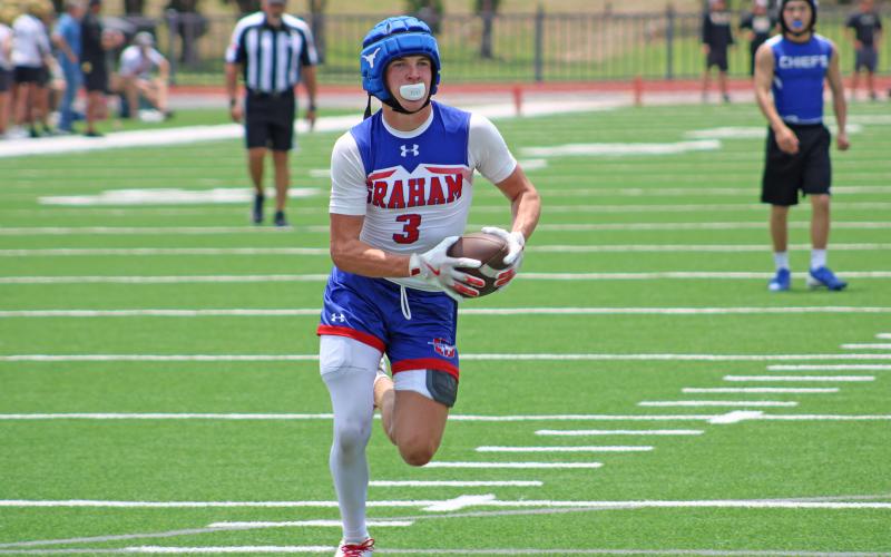 (ALEX HAVARDANSKY | THE GRAHAM LEADER) Parker Hale runs away from the defense for a walk in touchdown Saturday, May 31. Hale has emerged over the past several weeks as an elusive receiving threat in the passing game for Graham.
