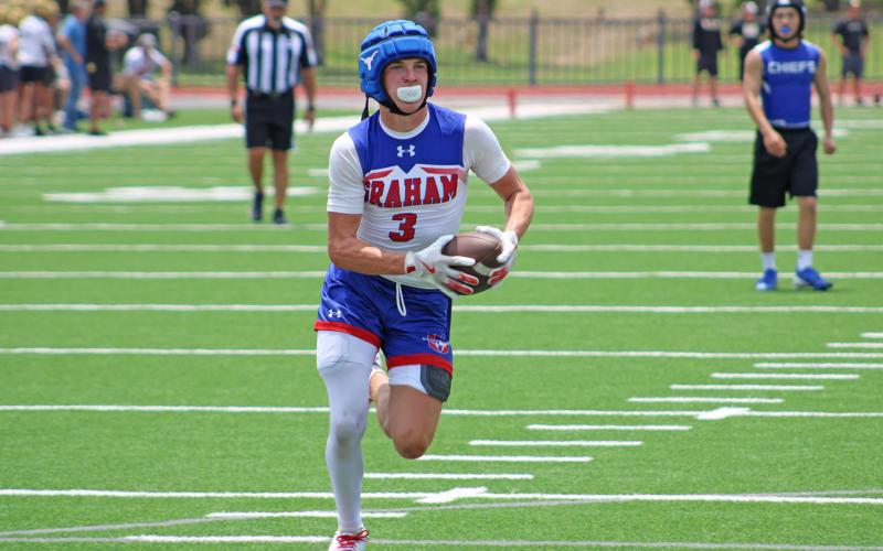 (ALEX HAVARDANSKY | THE GRAHAM LEADER) Parker Hale runs away from the defense for a walk in touchdown Saturday, May 31. Hale was an elusive receiving threat in the passing game for Graham. 