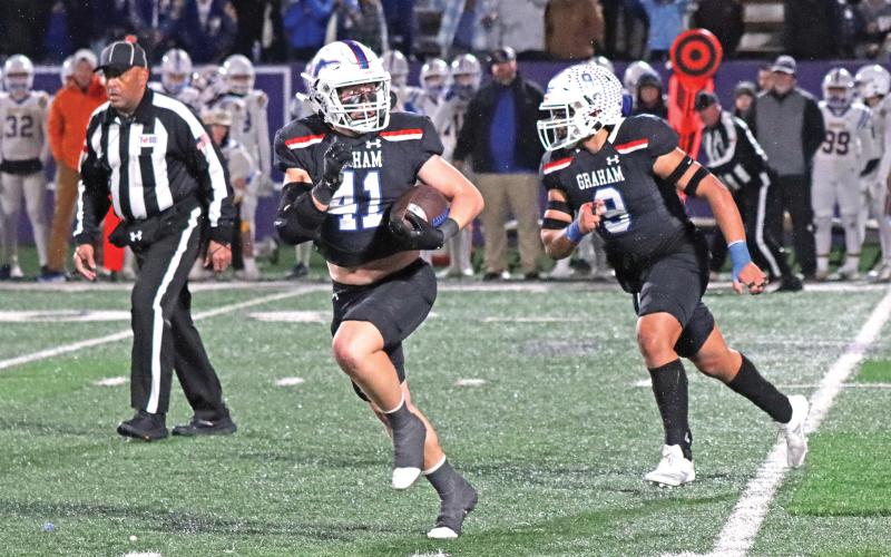 (ARCHIVE PHOTO | THE GRAHAM LEADER) Linebacker Jayton Hearne (41) checks over his shoulder as he begins to return an interception he caught while teammate Mateo Rodriguez (9) to block.
