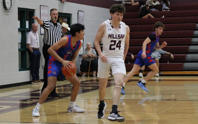 (ALEX HAVARDANKSY | THE GRAHAM LEADER) Obed Trejo looks to pass the ball up court after securing a rebound Tuesday, Nov. 18 against the Millsap Bulldogs. Trejo forced several key turnovers while also picking up four points in the Steers win. 