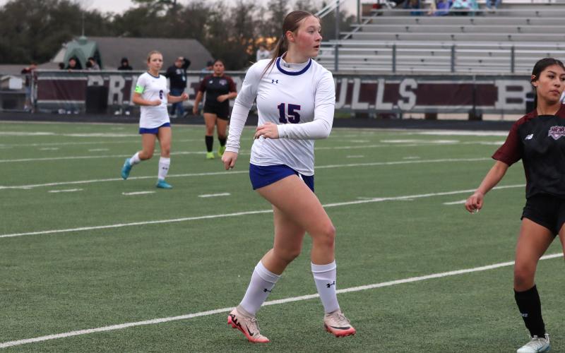 (KYLIE BAILEY | THE GRAHAM LEADER) Collins Weil follows through on a kick Friday, Feb. 20 against the Bridgeport Lady Bulls. The Lady Blues remained undefeated in district play with a 3-0 shutout victory. 