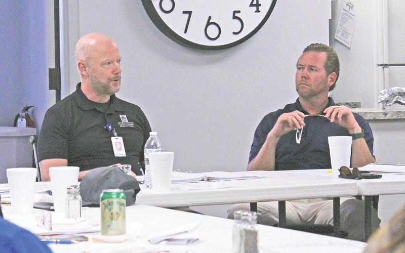 (TC GORDON | THE GRAHAM LEADER) Graham Regional Medical Center CEO Shane Kernell (left) speaks to the board during a recent meeting Wednesday, Sept. 25. The GRMC board approved the tax rate and budget for fiscal year 2025, as well as a three-year capital expenditure plan.