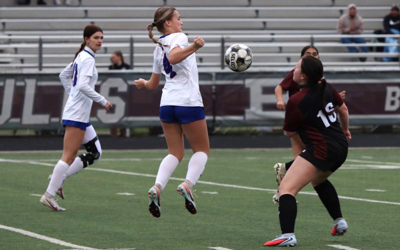 (KYLIE BAILEY | THE GRAHAM LEADER) Calen Dawson jumps up to black the ball Friday, Feb. 20 against the Bridgeport Lady Bulls. The defense was once again stellar for the Lady Blues in their fourth shutout in district play out of five games played. 