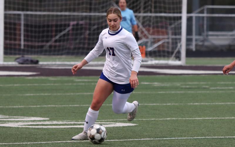 (KYLIE BAILEY | THE GRAHAM LEADER) Adi Pinkston drives the offense up field Friday, Feb. 20 against the Bridgeport Lady Bulls. The Lady Blues so far have scored 20 goals in district play and have only surrendered two goals defensively. 