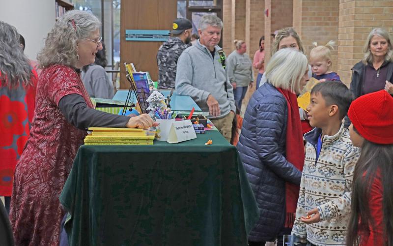 (THOMAS WALLNER | THE GRAHAM LEADER) Author Tabatha Waybright speaks with children at the Authors Day and Santa at the Library event in December 2024. Waybright will be returning along with 18 other authors Saturday, Dec. 6 .