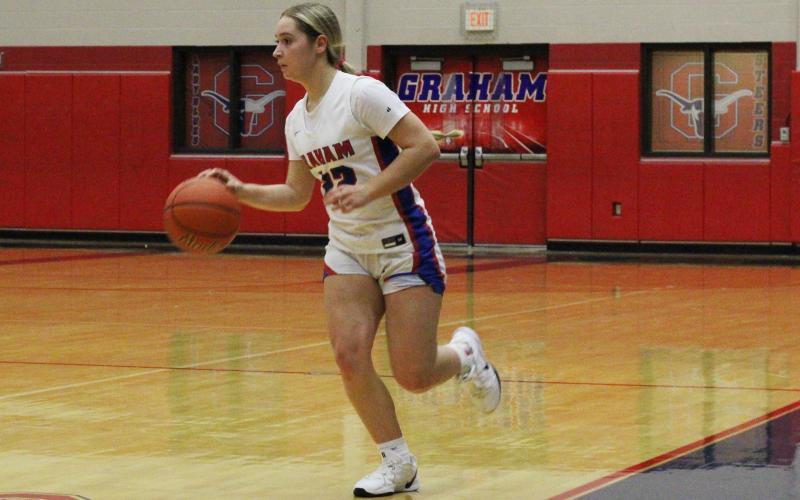 (ALEX HAVARDANSKY | THE GRAHAM LEADER) Adi Pinkston drives the ball up the floor Thursday, Nov. 20 against the Bowie Bowie Lady Rabbits. Pinkston helped tie the game in the fourth quarter for the Lady Blues in their 35-32 win.