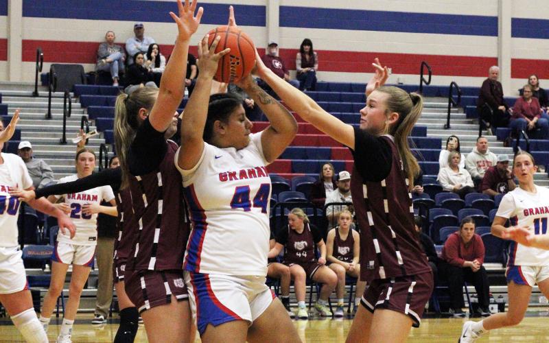 (ALEX HAVARDANSKY | THE GRAHAM LEADER) Gabbie Reyes fights the ball away from defenders in the Lady Blues’ matchup Thursday, Nov. 20. Reyes led the team in scoring in their opening match against City View at the Bowie tournament Monday, Nov. 24. 