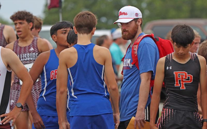 (KYLIE BAILEY | THE GRAHAM LEADER) Coach Quinton Fossett speaks with Steers runners prior to them competing Wednesday, Aug. 20 in the Nocona CC Relay.