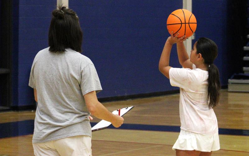 (ALEX HAVARDANSKY | THE GRAHAM LEADER) Lady Blues coaches teach campers how to shoot free throws Tuesday, June 3. This was one of several activities to teach the fundamentals of basketball at Lady Blues basketball camp.
