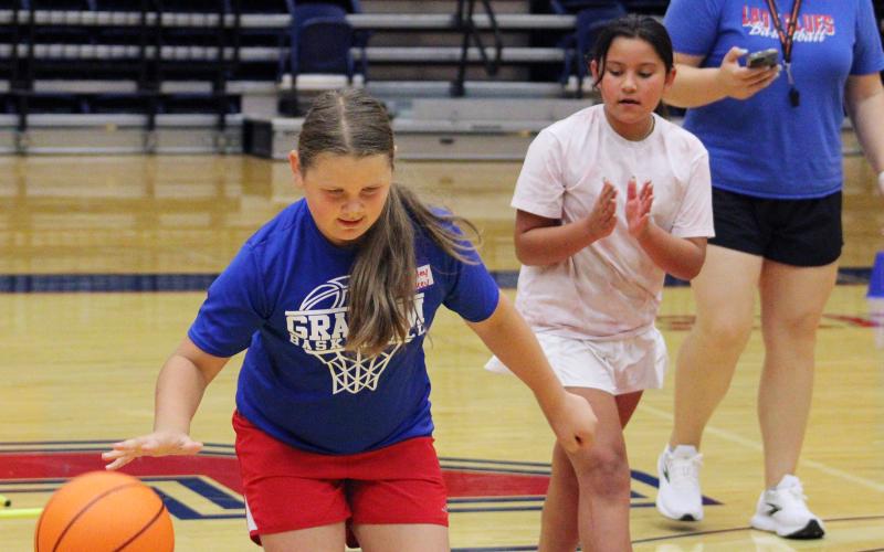 (ALEX HAVARDANSKY | THE GRAHAM LEADER) A Lady Blues camper practices dribbling on an obstacle course during Lady Blues basketball camp Tuesday, June 3. Teammates were also encouraged to cheer their Lady Blues teammates on.