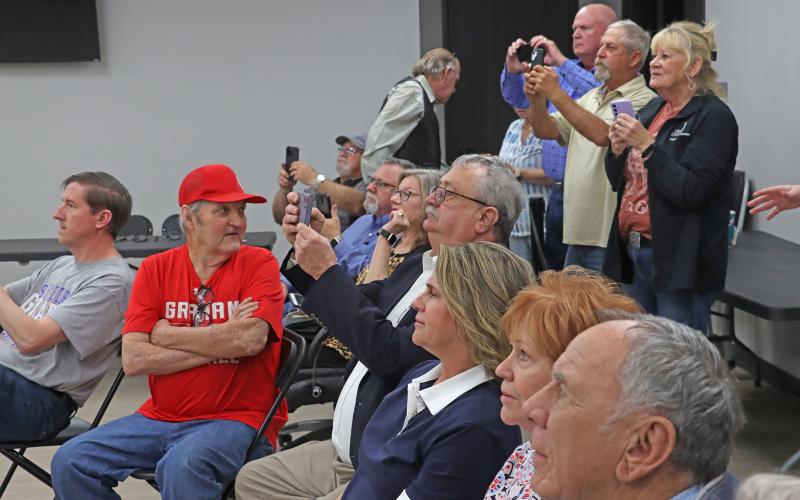 (THOMAS WALLNER | THE GRAHAM LEADER) Candidates and visitors to the Young County Annex look at election results as they are displayed on a screen Tuesday, March 3. Four local seats were contested in the Republican primary election.