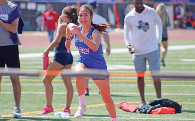 (ALEX HAVARDANSKY | THE GRAHAM LEADER) Emerie Stogner takes off in a high jump heat at the area meet Friday, April 11 in Abilene.