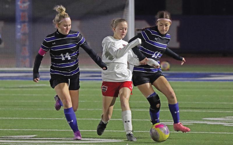 (THOMAS WALLNER | THE GRAHAM LEADER) Olivia Pettus (14) and Marisa Bueno (11) fight for possession of the ball during the Lady Blues game against Mineral Wells held Tuesday, March 4. The district finale resulted in a 2-0 win.