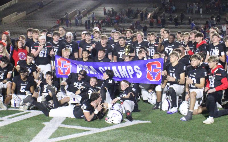 (ALEX HAVARDANKSY | THE GRAHAM LEADER) The Steers celebrate with their area championship trophy Friday, Nov. 21 after defeating the Lubbock Cooper Liberty Patriots 35-28. Head coach Clay McChristian said he was proud of the team’s fight against a tough opponent. 