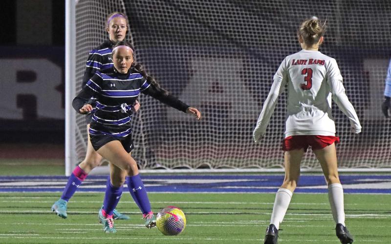 (THOMAS WALLNER | THE GRAHAM LEADER) Senior Kinsley Amburn looks to pass the ball to push it down the field Tuesday, March 4. Amburn was one of four seniors recognized before the senior night game.