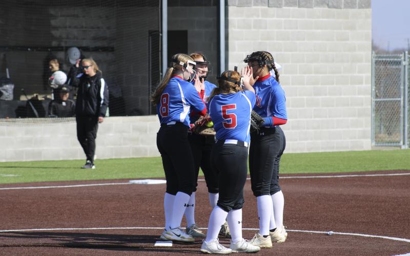 (MIKE WILLIAMS | THE GRAHAM LEADER) Zoey Harrell (8), Reese Calhoun (5), Olga Morales (far right) and Emily Lawson (top middle) celebrate a strikeout thrown by Zoey Harrell during the Lady Blues’ 2-1 scrimmage win over Rider Saturday morning at Graford High School.