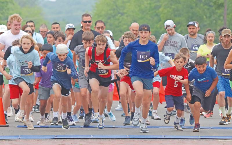 (ARCHIVE PHOTO | THE GRAHAM LEADER) Participants in the 5K race for the 2024 Run for the Children event take off from the starting point at Third Street and Oak Street. The event this year will be taking off at the same location Saturday, April 26.
