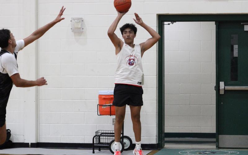 (ALEX HAVARDANSKY | THE GRAHAM LEADER) Obed Trejo attempts a corner three against the May Tigers in their matchup Tuesday, June 3. Trejo established himself as a threat on the perimeter.