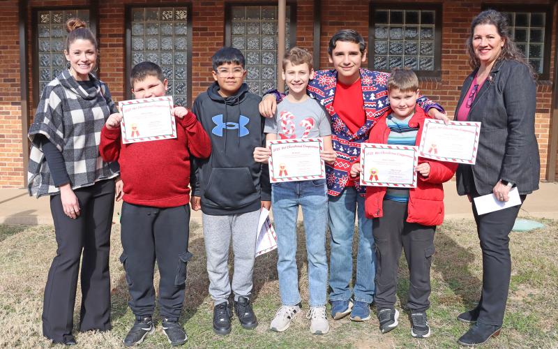(THOMAS WALLNER | THE GRAHAM LEADER) Members of Cocoa Cabin pose for a photo with members of their benefiting nonprofit the Library of Graham. Team members are Jordan Cotton, Branden Cotton, Eli Dixon, Jacob Huerta, Marcus Monrreal, Witten Taylor and Austin Tamplen.