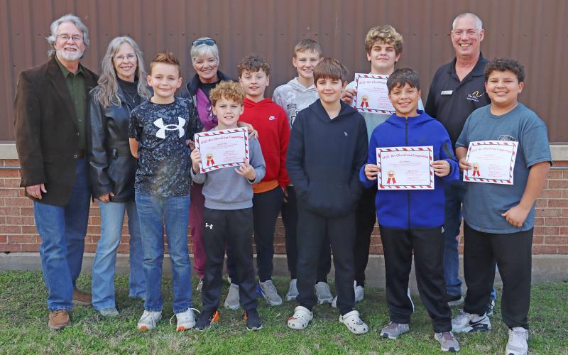 (THOMAS WALLNER | THE GRAHAM LEADER) Members of The Little Grinches Cocoa Shop pose with members of their benefiting nonprofit HERO House. Team members are Miles Elliott, Jesse Ramos, Jace Roberts, Dax Duensing, Everett Riley, Logan Cox, Josiah Taylor and Easton Budarf.