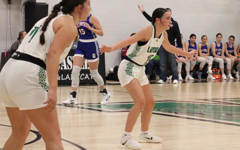 (ALEX HAVARDANSKY | THE GRAHAM LEADER) Rae’Lynn Bennett, 15, and Emma Hawkins, 11, play up on defense in one of the Ladycats’ previous matchups. The Ladycats fought hard Friday, Dec. 12 but lost to the Lady Eagles 37-17. 