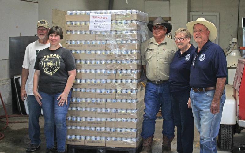 (ALEX HAVARDANSKY | THE GRAHAM LEADER) Those who serve at Murray Volunteer Fire Department pose with their delivery of drinking water cans Thursday, June 5. This delivery came from a grant which Anheuser-Busch dedicates to departments combating wildfires