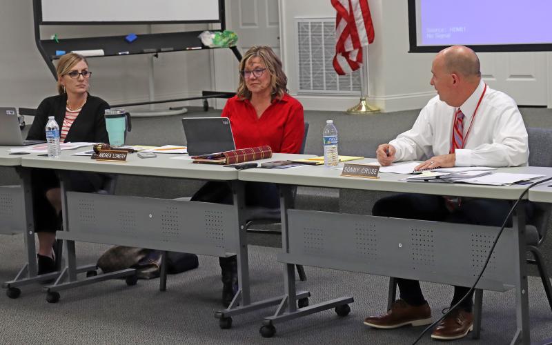 (THOMAS WALLNER | THE GRAHAM LEADER) Superintendent Sonny Cruse (right) speaks with the Graham ISD Board of Trustees during their meeting Wednesday, Feb. 14. The board approved the upcoming 2024-2025 school year calendar and continued with a modified four-day calendar. Shown from left to right are board members Lauren Mahaney, Andrea Lowery and Cruse.