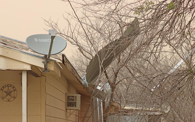  (THOMAS WALLNER | THE GRAHAM LEADER) The top of a roof in the 300 block of Cement Mountain Road blew off and onto a power line, pressing it to a home Friday, March 14. High winds and dust were blown into Young County and other portions of the state Friday. 