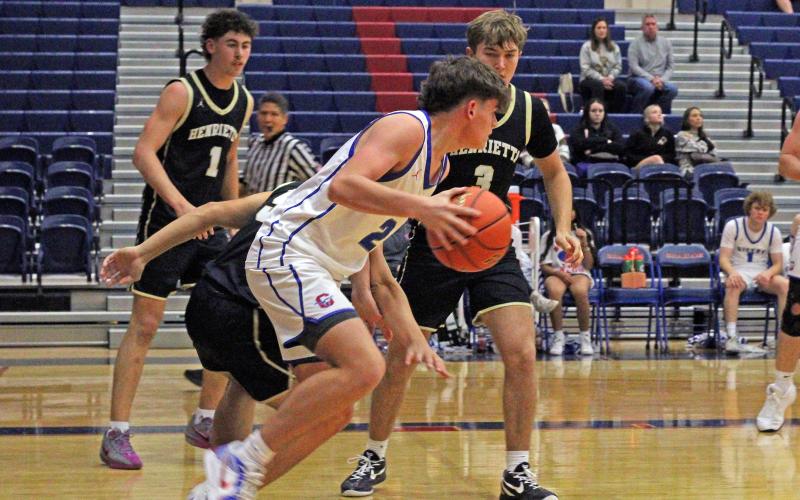 (ALEX HAVARDANSKY | THE GRAHAM LEADER) Bryce Martin dribbles the ball outside of the paint Tuesday, Dec. 9 against Henrietta. Martin scored five points in the Steers’ 63-39 loss to the Bearcats.