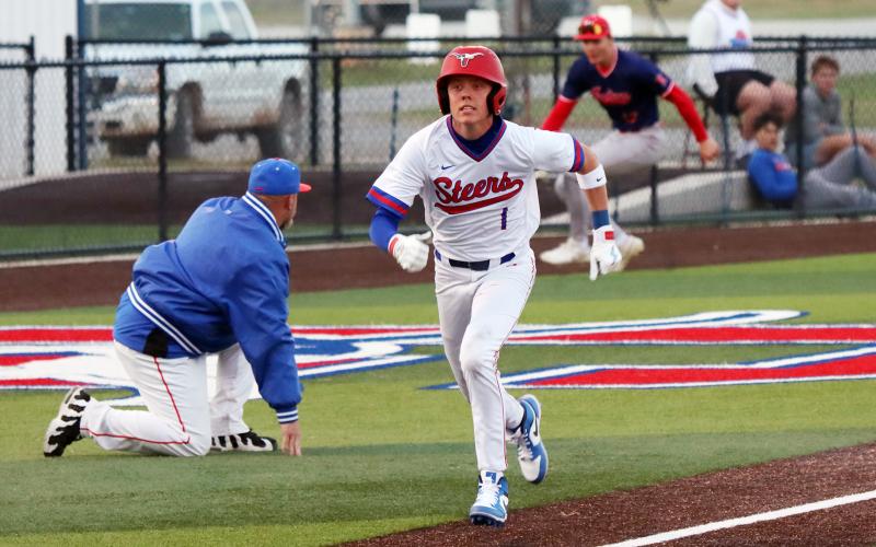 (THOMAS WALLNER | THE GRAHAM LEADER) Senior Tanner Hurford makes a mad dash for home as a player with the Jim Ned Indians scrambles for the ball in the background. Hurford and four other seniors were honored during senior night Tuesday, March 17.