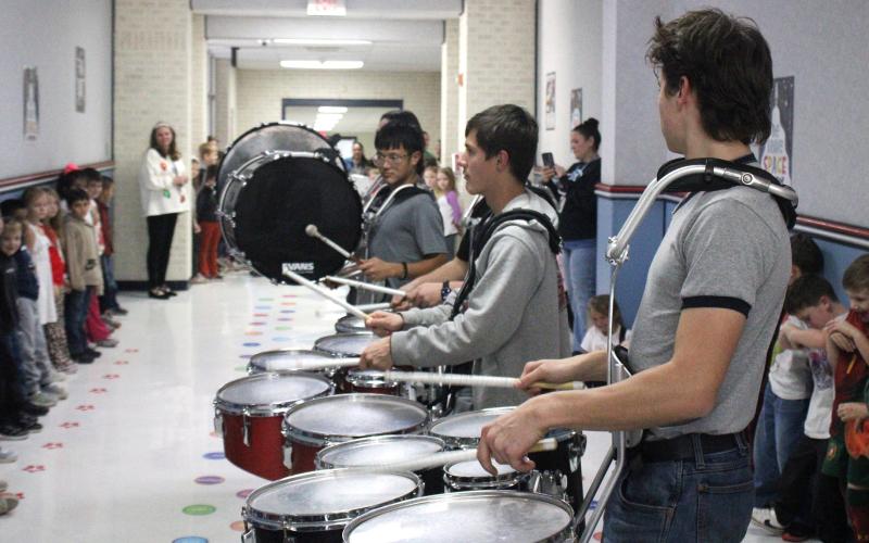 (ALEX HAVARDANSKY | THE GRAHAM LEADER) The Rompin’ Stompin’ Big Blue Band drumline led the Graham Public Education Foundation during their prize patrol distribution Thursday, Dec. 11. The nonprofit foundation donated over $100,000 to Graham ISD teachers.