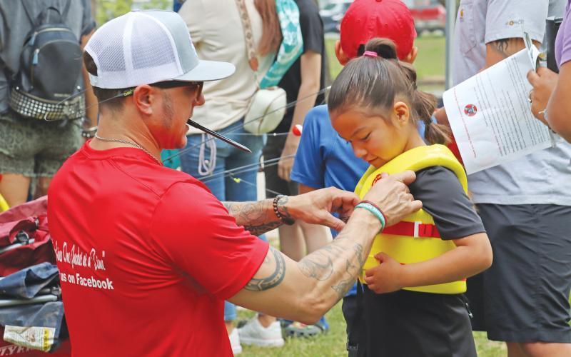 (ARCHIVE PHOTO | THE GRAHAM LEADER) A child is fitted for a life jacket during the Family Fun and Fishing event in 2024. There will be a life jacket fitting from the Remembering Wyatt Dale Water Safety organization Saturday, June 21.