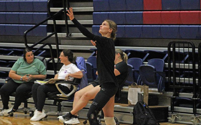 (ALEX HAVARDANSKY | THE GRAHAM LEADER) Tara Dawson starts the Lady Blues matchup at the service line Monday, June 9. Dawson is returning to the team after suffering an ACL injury for her final season at Graham High School.