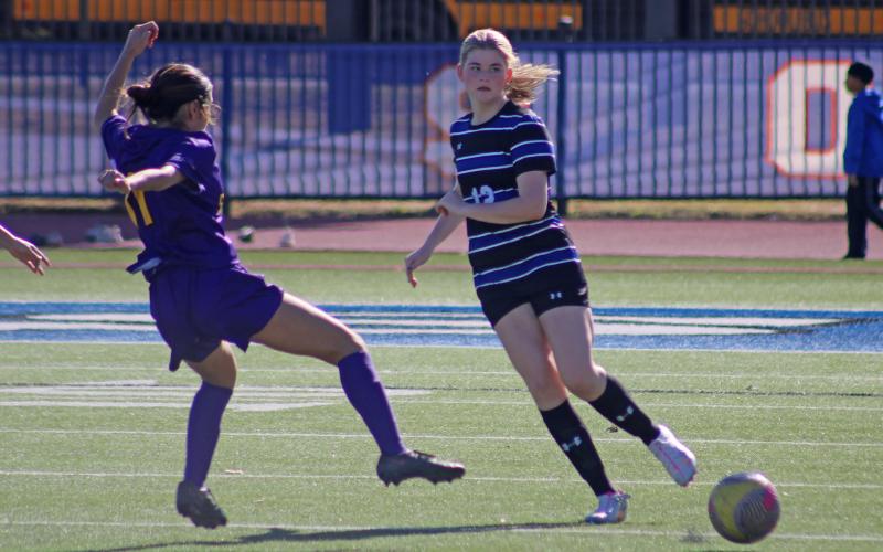 (ALEX HAVARDANSKY | THE GRAHAM LEADER) Jensen Pettus kicks the ball to the outside of the field Friday, Dec. 12 against the Sanger Lady Indians. The Lady Blues got their first taste of on-the-field action in their scrimmage match, winning 8-0. 