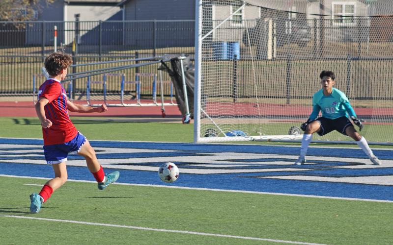 (ALEX HAVARDANSKY | THE GRAHAM LEADER) Hudson Weatherman fires a ball off his right foot to the net Friday, Dec. 12 against the Sanger Indians. The Steers got their first taste of on-field action in their scrimmage match with the Indians. 