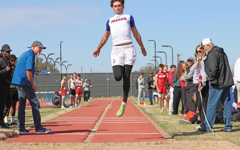 (THOMAS WALLNER | THE GRAHAM LEADER) Jordan Alexander completes a triple jump during the PK Relays held Saturday, March 15 in Graham. 