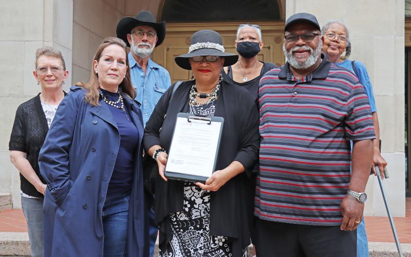 (THOMAS WALLNER | THE GRAHAM LEADER) Rev. Vanessa Sims, members of the Young County Historical Commission, community members and family of Sims pose on the Young County Courthouse steps Friday, May 3. Sims filed an official declaration from the Texas Historical Commission which is one of the final steps to receive a Historic Texas Cemetery designation. 