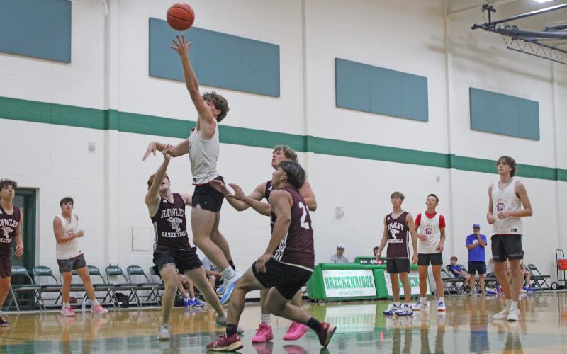 (ALEX KIELAR | THE GRAHAM LEADER) Star player of the Steers, Cooper Corley, attempts a layup against the Hawley Bulldogs in the final week of the summer basketball league Tuesday, June 24. Corley continued his strong offensive production during the summer league as the leading scorer.
